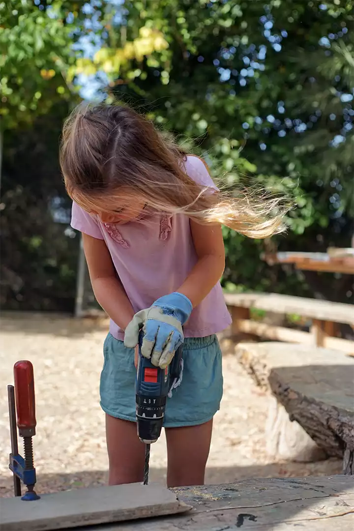 A camper learning to work with wood