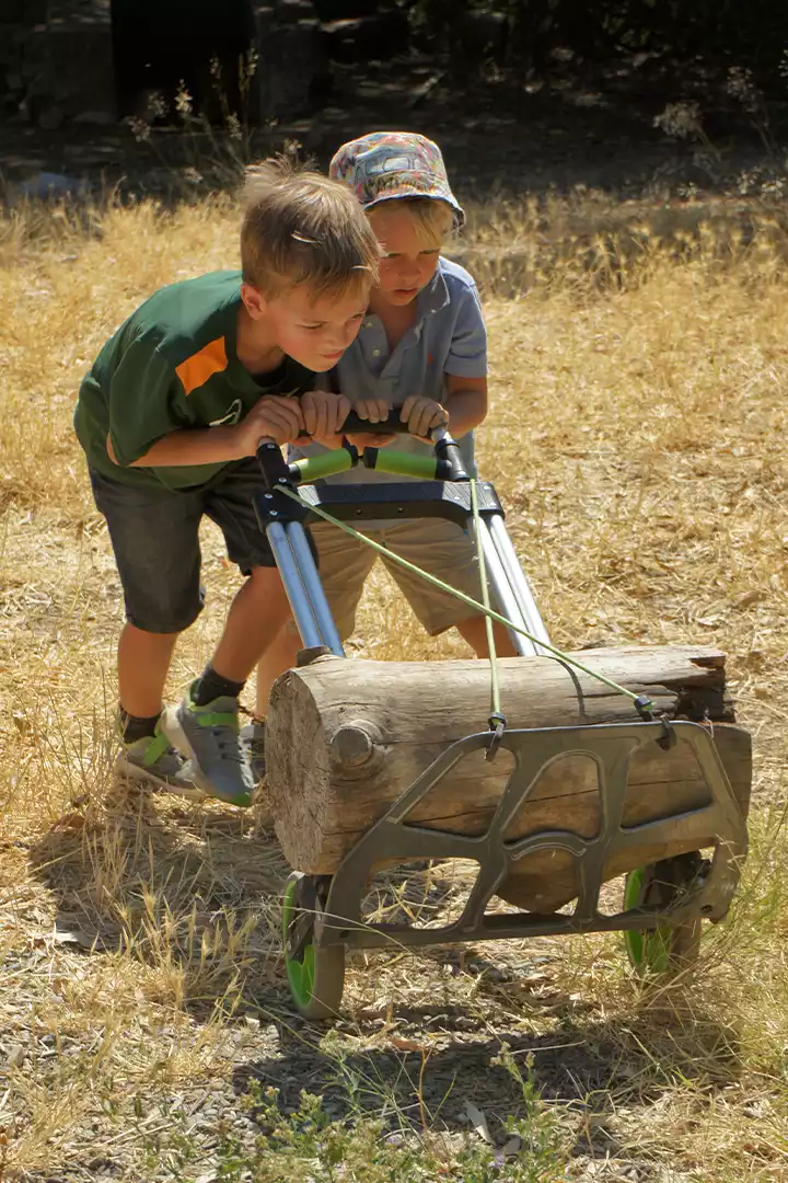 Campers working together to move a log