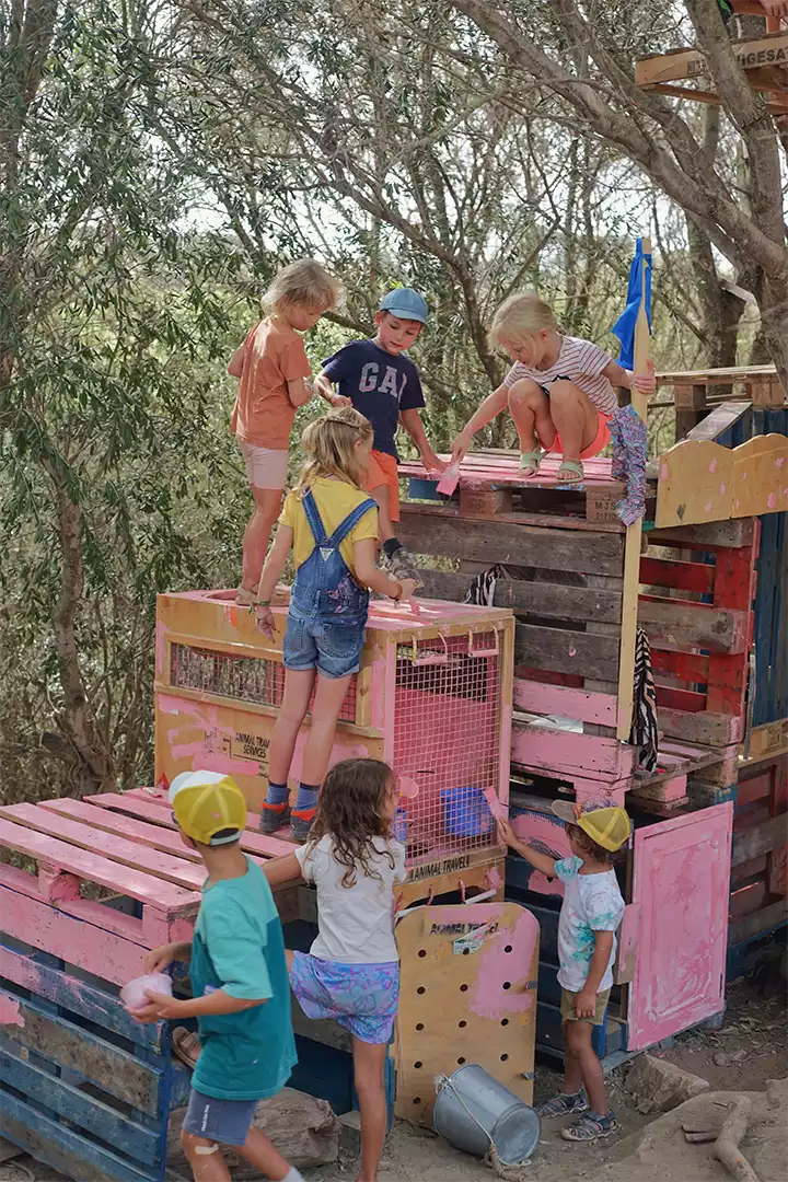 Children painting a camp project