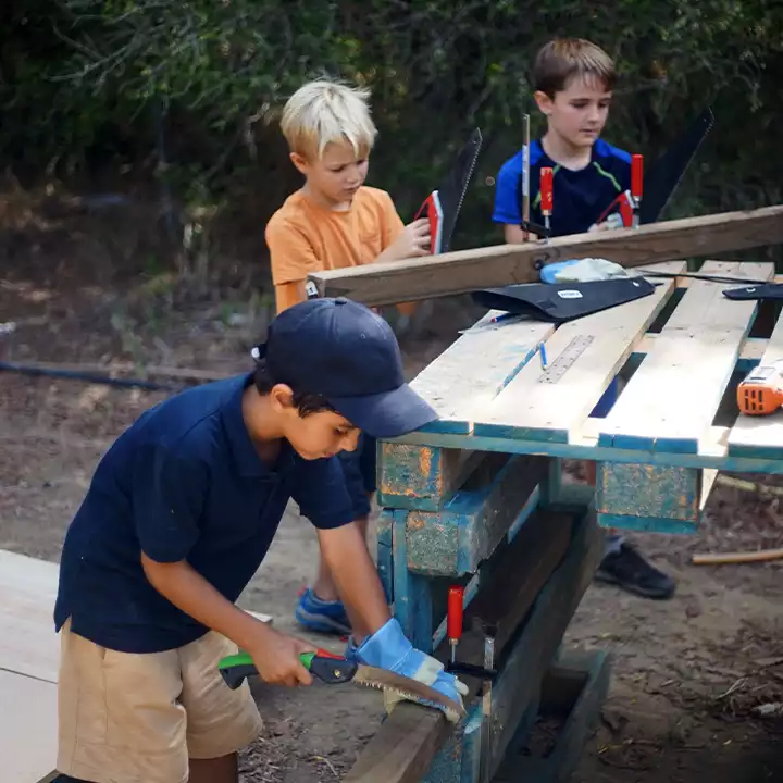 A child learning carpentry